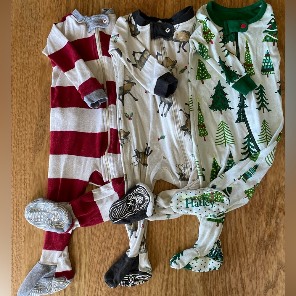 Set of 3 Christmas zip up onesie pajamas.